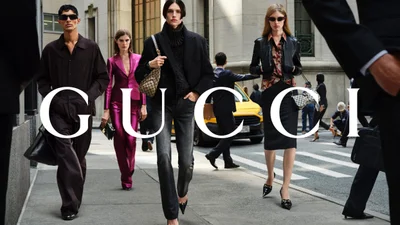 Models walking down a New York street in Gucci Fall 2026 campaign featuring luxury apparel and monogram handbags.