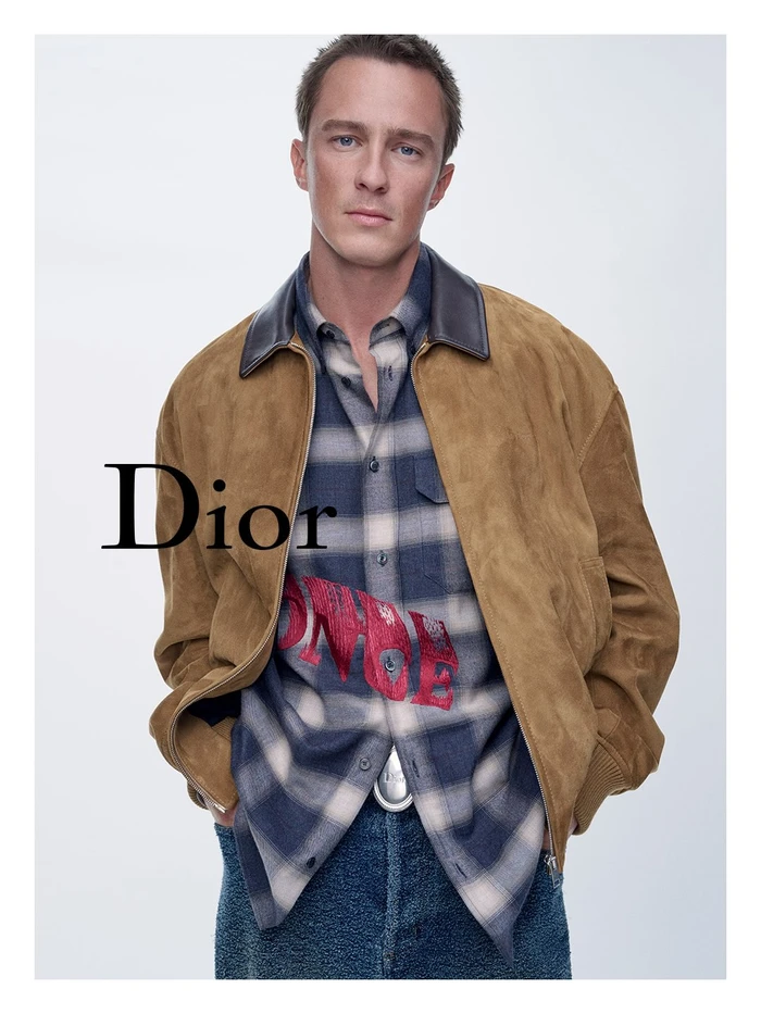 Drew Starkey in a camel suede jacket and plaid shirt for Dior Cruise 2027 campaign photographed by Sam Rock