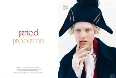Model wearing a dark tricorn hat and period jacket with cravat for More or Less Magazine