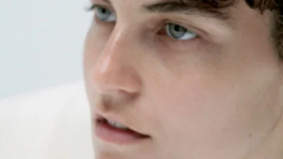 Close-up portrait of a model with blue eyes against a white background for Index N°1 by Nicole Maria Winkler