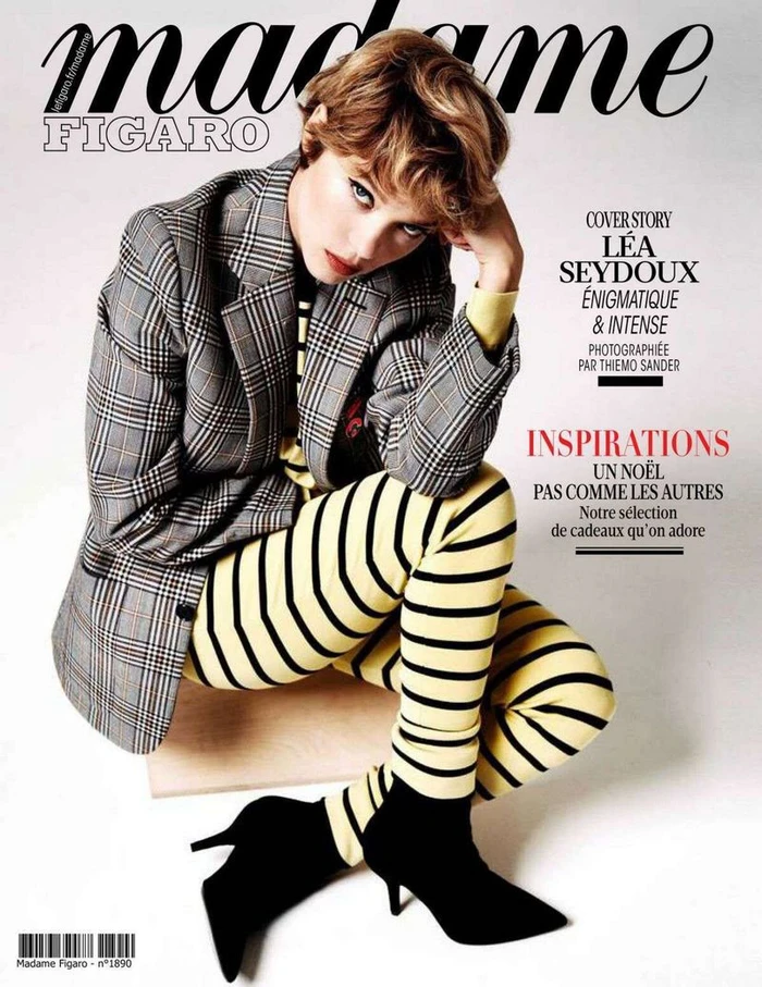 Lea Seydoux on Madame Figaro magazine cover wearing a plaid blazer and striped yellow leggings against a white background