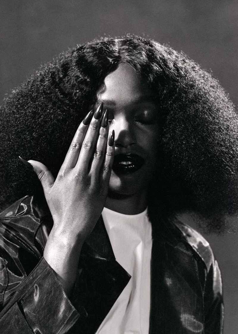 Portrait of John Glacier with hand covering eye featuring long dark nails and voluminous textured hair for i-D Magazine