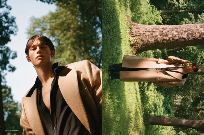 Model Josiah Turner in a beige coat and black shirt outdoors among trees for Men's Folio Singapore