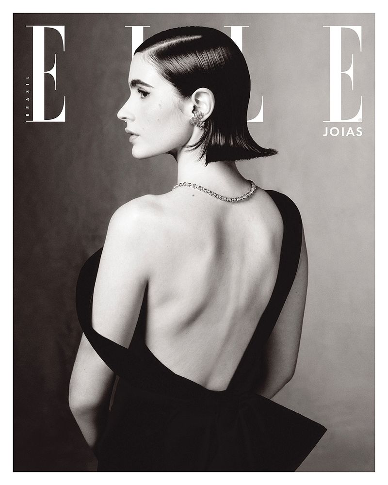 ELLE Brasil cover featuring an adult female model wearing jewelry and a black dress against a monochrome grey background in a studio shot.