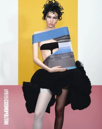 Fashion-forward image of a woman in a conceptual outfit against a vibrant two-tone backdrop, exuding editorial style and creative expression.