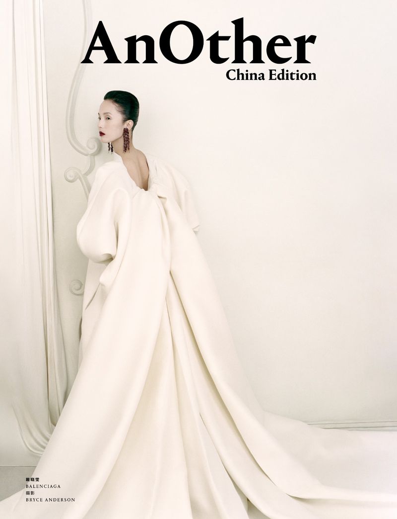 Model in a voluminous white gown with a sweeping train standing against a light background for AnOther China Edition