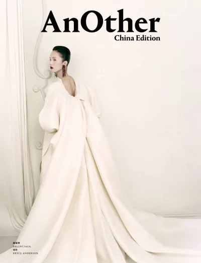 Model in a voluminous white gown with a sweeping train standing against a light background for AnOther China Edition