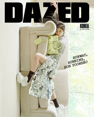 Roh Yoonseo on Dazed Korea July 2026 digital cover, wearing patterned dress and white sneakers while lying on a sofa.