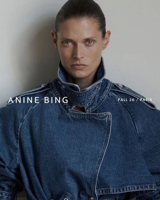 Model Malgosia Bela wearing an oversized denim jacket with a high collar against a neutral background for Anine Bing Fall 2026