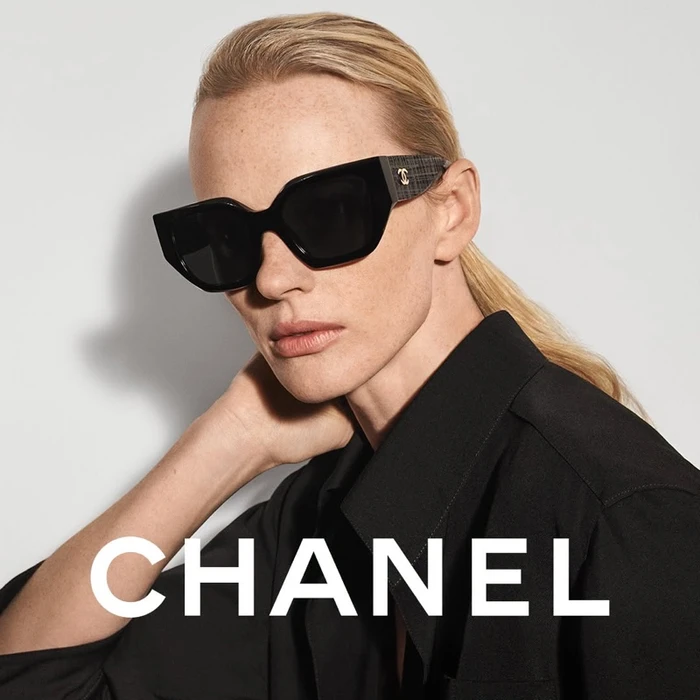 Model wearing black sunglasses and a black shirt against a white backdrop for Chanel Coco Neige 2026