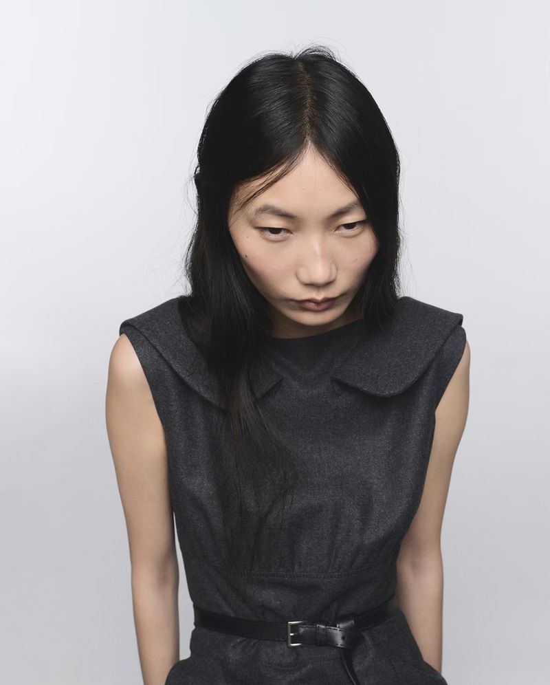 Model Ruyu Chen wearing a dark wool dress against a seamless white background for Prada Re-Cashmere and Re-Wool