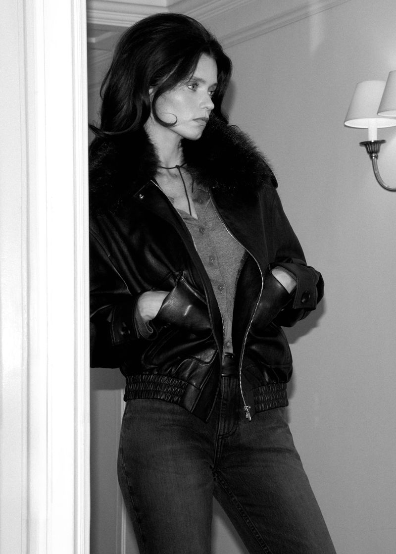 Abbey Lee posing indoors in a black leather jacket and jeans for Mango Fall 26, photographed by Larissa Hofmann.