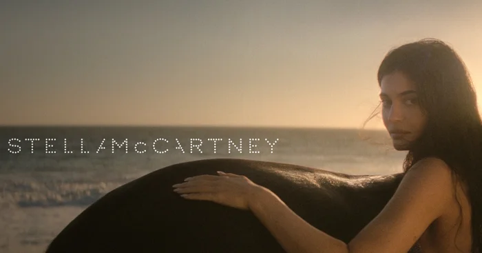 Kylie Jenner posing on a sandy beach at sunset for the Stella McCartney Wild Horses campaign, photographed by Gia Coppola.