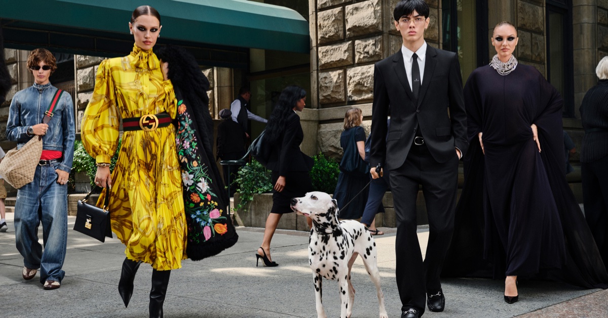 Group of four models walking on a city sidewalk alongside a Dalmatian dog for Gucci shot by Peter Funch