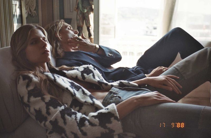 Two models relaxing on a sofa in an interior setting, shot for Numéro Istanbul editorial by Emre Dogru