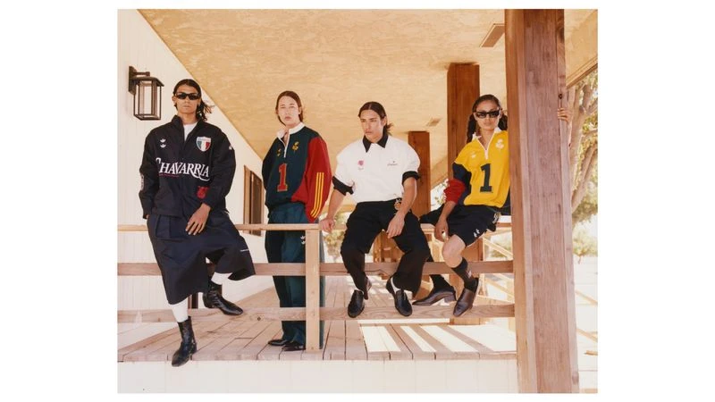 Four models in sporty apparel sitting on a wooden porch railing for Exhibition Magazine project Huron, California.
