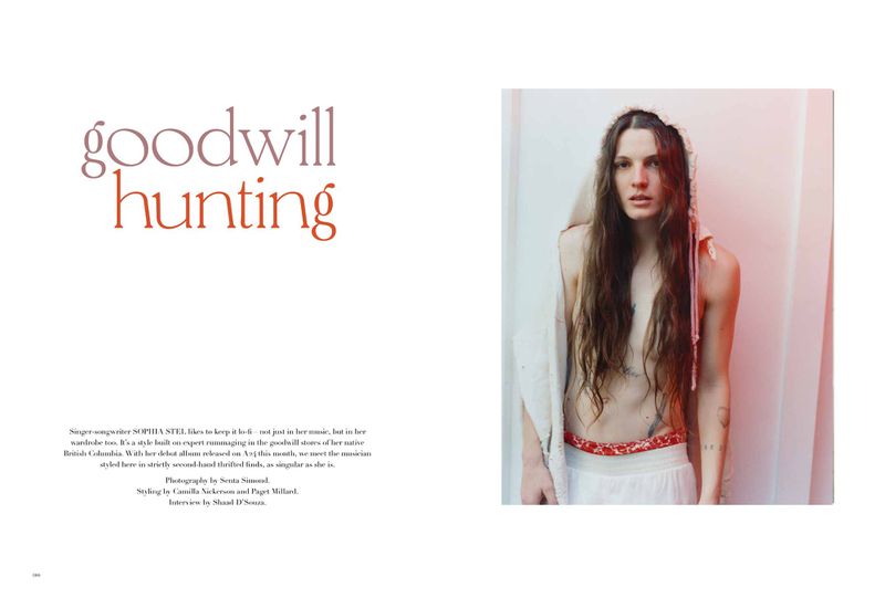 Editorial spread with title text on the left and a portrait of a long-haired woman in white clothing on the right against a plain wall.
