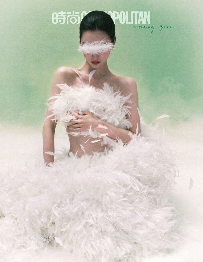 Chen Duling wearing a white feather dress against a soft green background for Cosmopolitan China