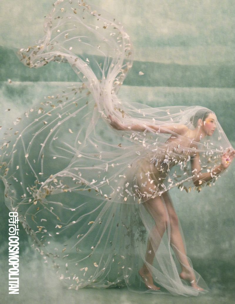 Chen Duling in a translucent veil dress with floating floral appliques against a textured green background for Cosmopolitan China by Songze Tu