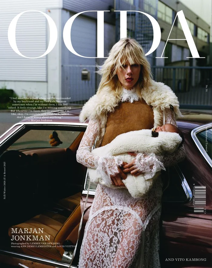 Marjan Jonkman holding a baby in front of a car for an ODDA Magazine editorial cover