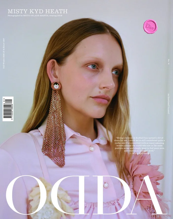 Misty Kyd Heath wearing a pink blouse and a long beaded earring for an ODDA Magazine editorial cover portrait