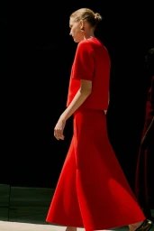 Model wearing a vibrant red short sleeve top and matching long skirt against a dark background for ME+EM August Lookbook