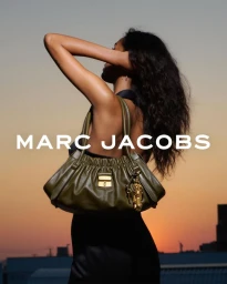 Model Mona Tougaard posing with an olive green leather handbag against a sunset sky for Marc Jacobs Fall 2025 Campaign