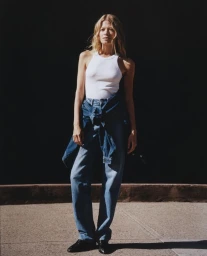 Model Schirin Frosch wearing a white tank top and blue denim jeans for the ALIGNE Denim Campaign 2025 shot by Ivan Bideac