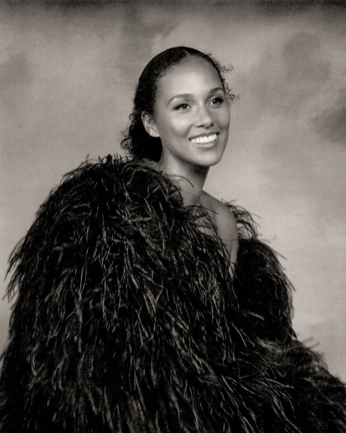 Alicia Keys smiling in a feathered coat against a mottled textured background for a Vogue Italia editorial portrait