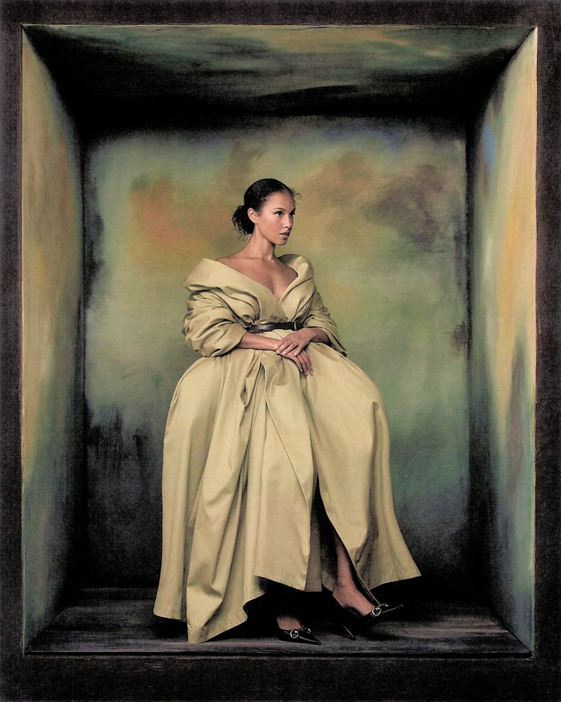 Alicia Keys seated inside a box-like set wearing a voluminous tan dress for Vogue Italia photographed by Szilveszter Mako