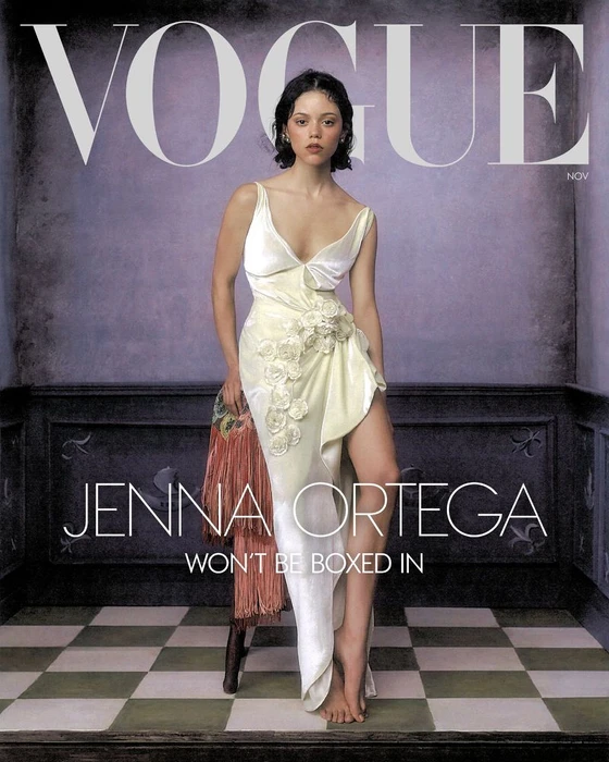 Jenna Ortega in a white silk dress posing on a checked floor for American Vogue magazine