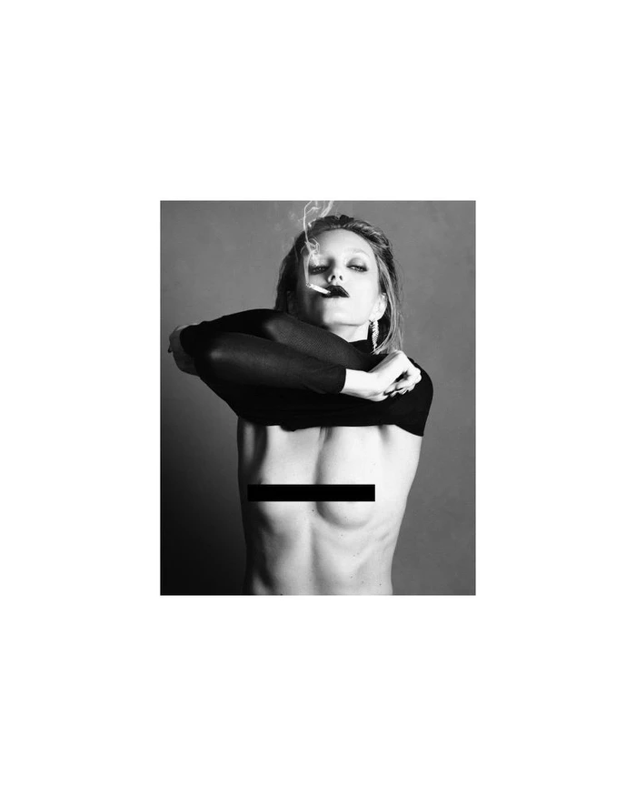 Model Anja Rubik smoking a cigarette with dark lipstick in a black-and-white fashion portrait for Double Vision by Luigi & Iango