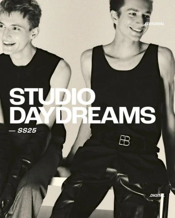 Editorial fashion shot of two slender adult male fashion models in dark tank tops and pants, posing in front of a neutral background.