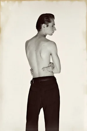 Shirtless male model with dark hair wearing black trousers against a neutral background for Le Mile Magazine