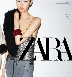 Model Sijia Kang wearing a sequined dress and holding a black faux fur stole for Zara fall winter woman collection.