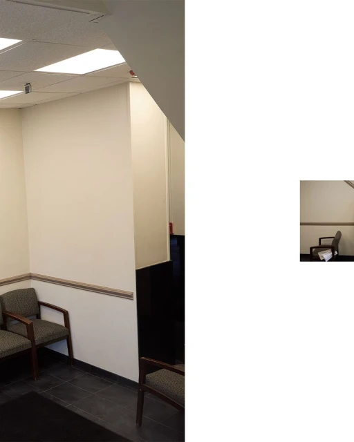 Indoor waiting area with chairs against a wall under bright fluorescent lighting. Interior of a commercial or healthcare facility.