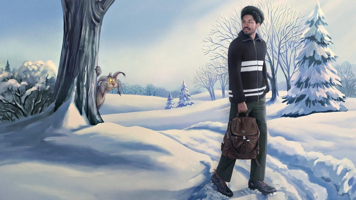 Kelvin Harrison Jr. wearing a striped zip sweater and dark trousers carrying a brown backpack in a snowy winter landscape