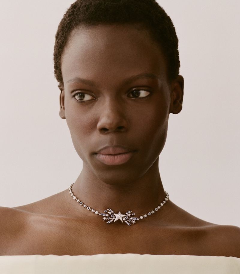 Model Agel Akol wearing a star-motif diamond choker necklace against a neutral background for Heroine Magazine.