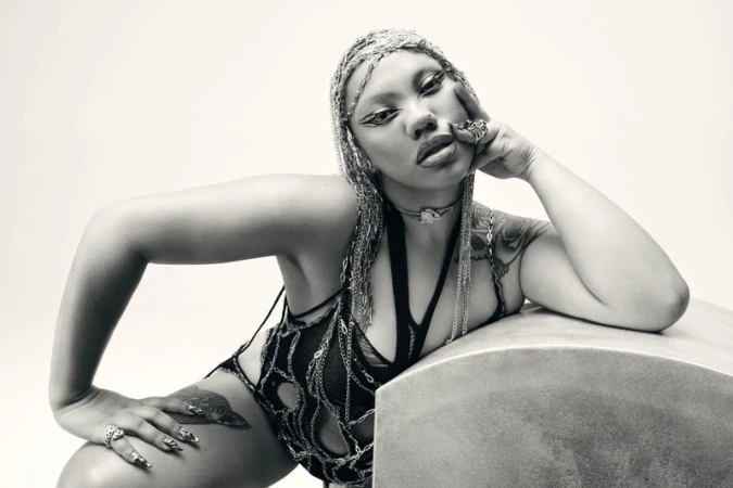 Parris Goebel wearing chain headdress and dark cutout apparel against a light backdrop for Harper's Bazaar Australia