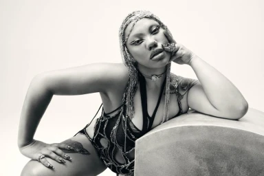 Parris Goebel wearing chain headdress and dark cutout apparel against a light backdrop for Harper's Bazaar Australia