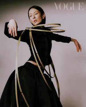 Model wearing black attire wrapped in metallic gold hoops for the Petal Power project in Vogue Taiwan.