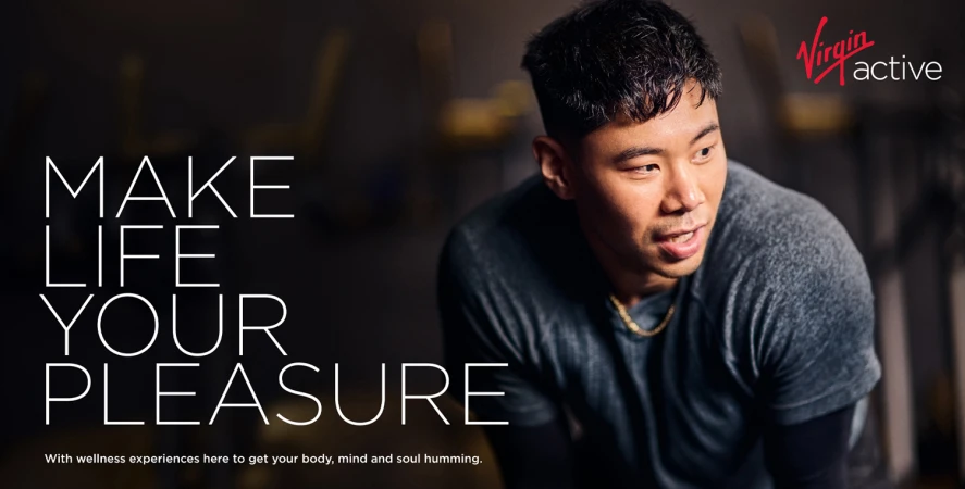 Asian male portrait with fitness motivation text, gray shirt, studio setting, Virgin Active logo, promoting wellness and lifestyle.