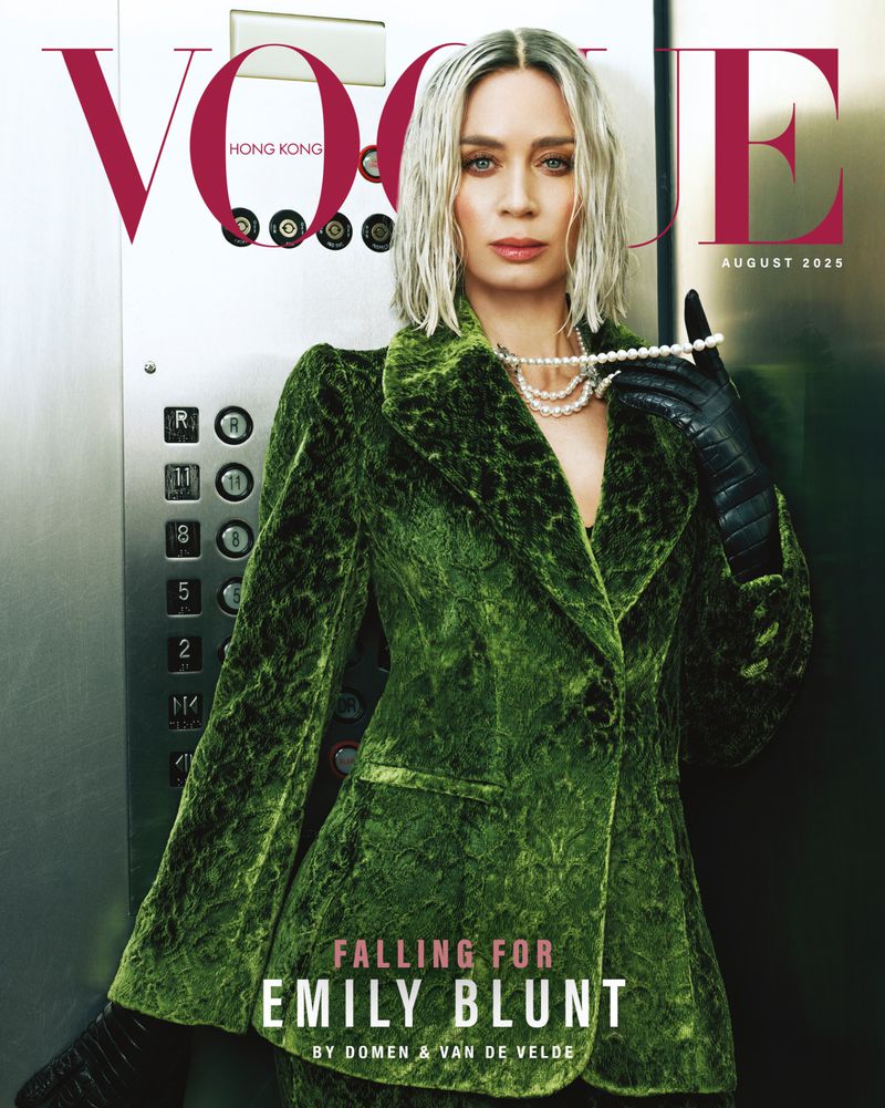 Vogue Hong Kong cover featuring Emily Blunt in a green velvet suit with pearl necklace in an elevator, August 2025 issue.