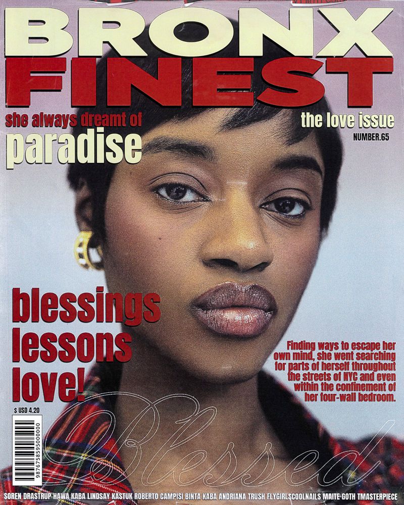 Magazine cover featuring a close-up shot of a Black woman with glossy lips, wearing a plaid top, against a soft background, and bold typography.