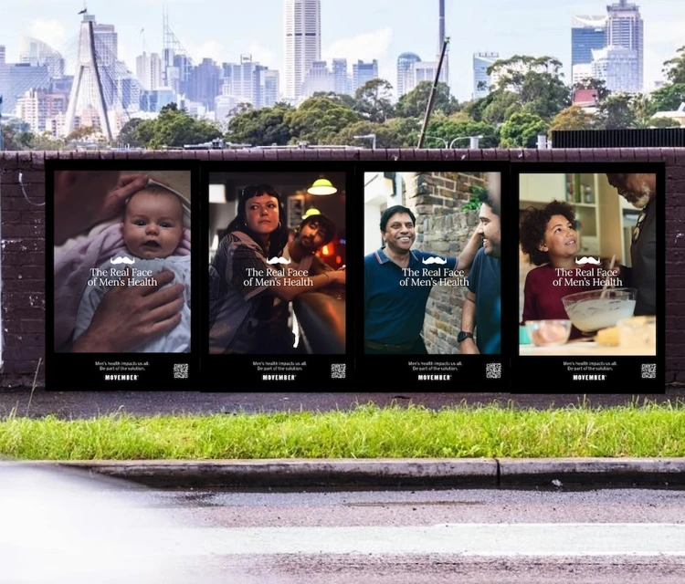 Outdoor advertising banner featuring four different portraits of people for men's health campaign set against a city skyline background.