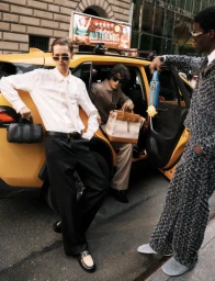 Three male models in sunglasses posing around a yellow taxi on a city street for Flaunt