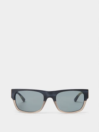 Close-up product shot of modern sunglasses with grey lenses, set against a bright white background. Fashion accessory, eyewear.