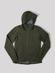Olive green hooded waterproof zip-up jacket laid flat on a light grey seamless studio background.