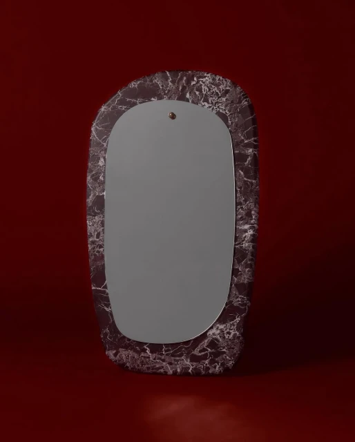 Rectangular mirror with rounded edges, set in a marble-patterned frame against a deep red background, featuring a modern, minimalist design.