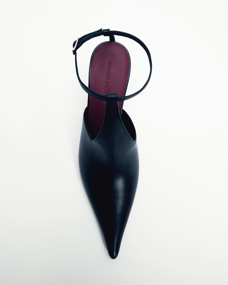 Elegant black leather stiletto heel featuring a pointed toe and ankle strap on a clean white background, offering a sophisticated look.